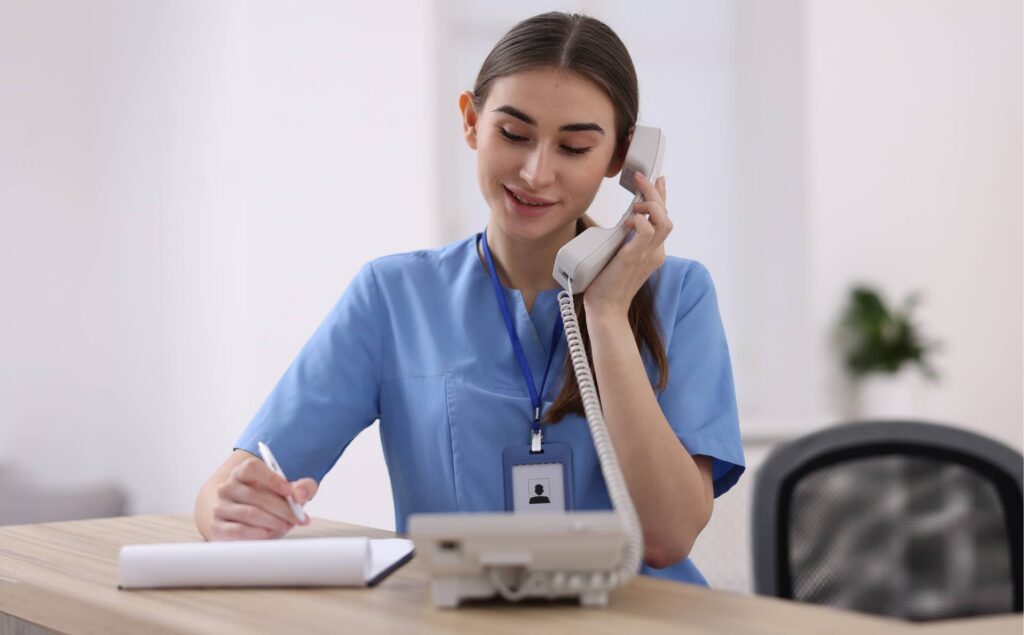 Admissions department staff member answering a call professionally.