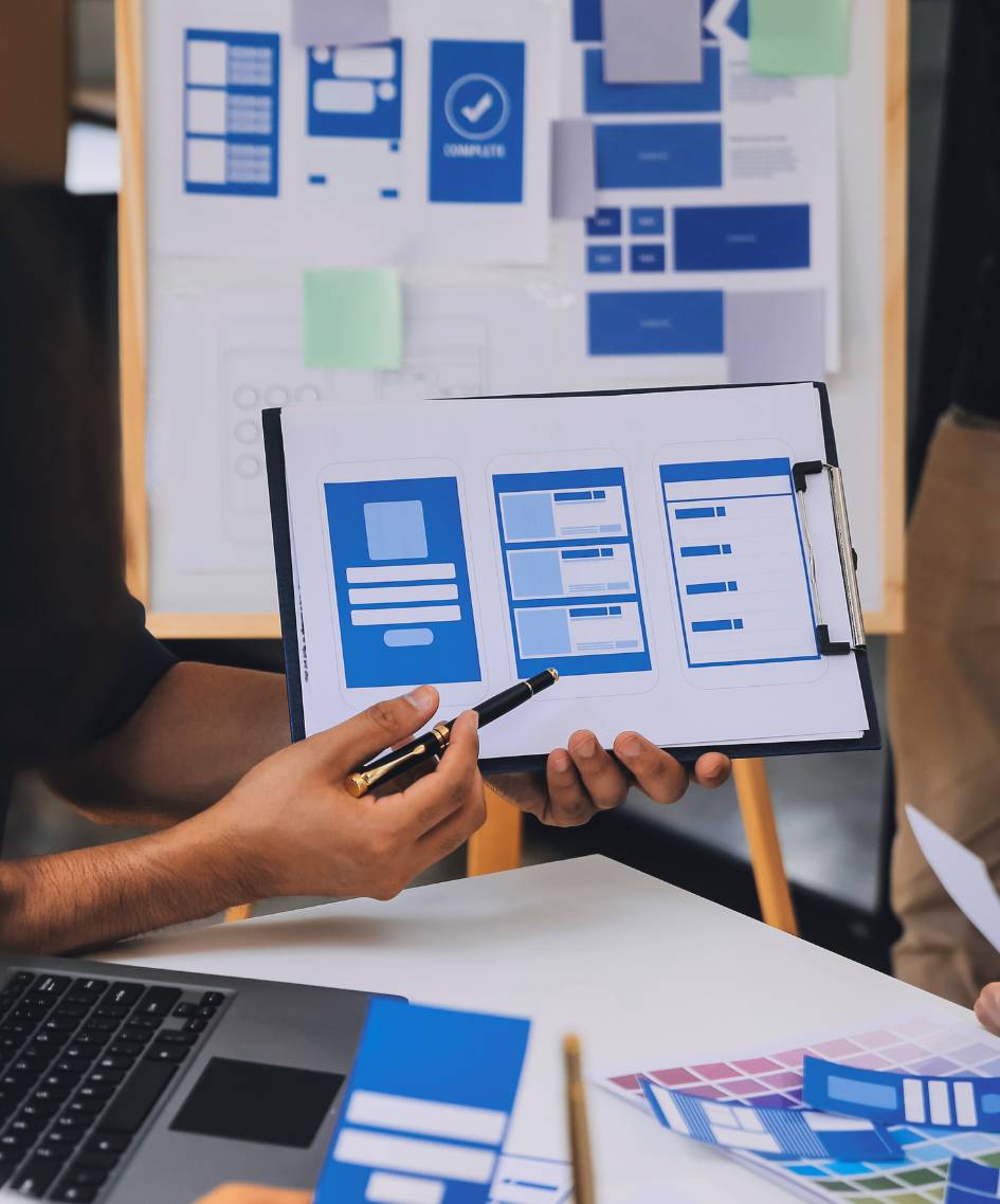 A team works on blueprints for web dev through our web design services.