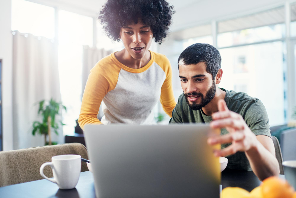 Couple using laptop while learning Google Business Profile optimization tips
